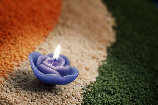 Candle in the middle of coloured pulses