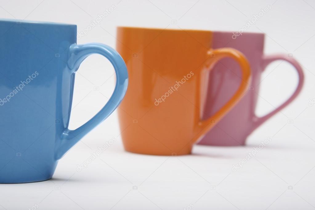 Colourful mugs in a row