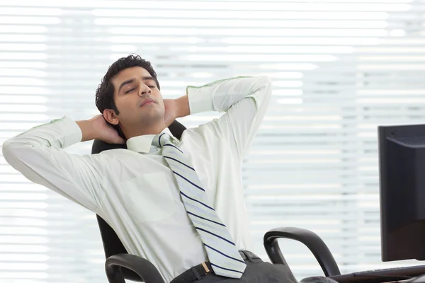 Businessman relaxing on chair — Stock Photo, Image