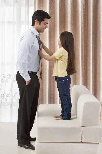 Daughter adjusting father's tie — Stock Photo, Image