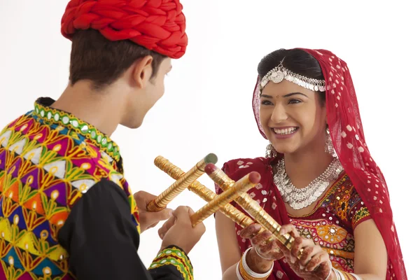 Couple with sticks dancing — Stock Photo, Image