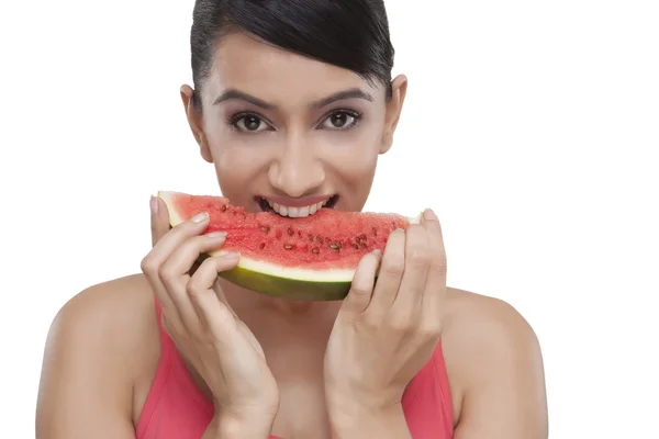 Young woman biting slice of watermelon — Stock Photo, Image