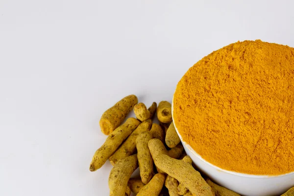 Curcuma in polvere in ciotola bianca con bastoncini di curcuma — Foto Stock