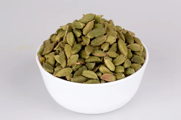 Cardamom on white cup with white background — Stock Photo, Image