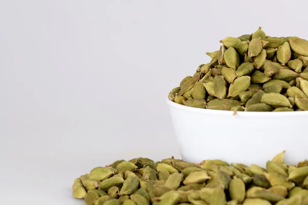 Cardamom on white cup with white background — Stock Photo, Image