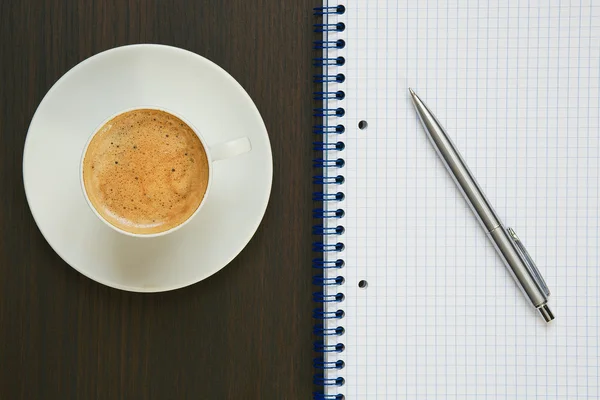 Coffee, pen and notebook.