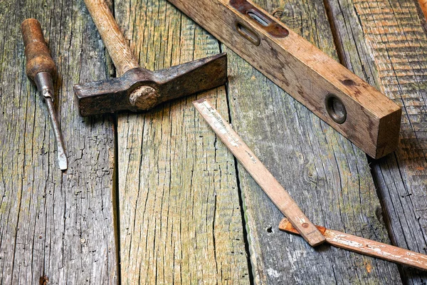 Old tools on a wooden background — Stock Photo, Image