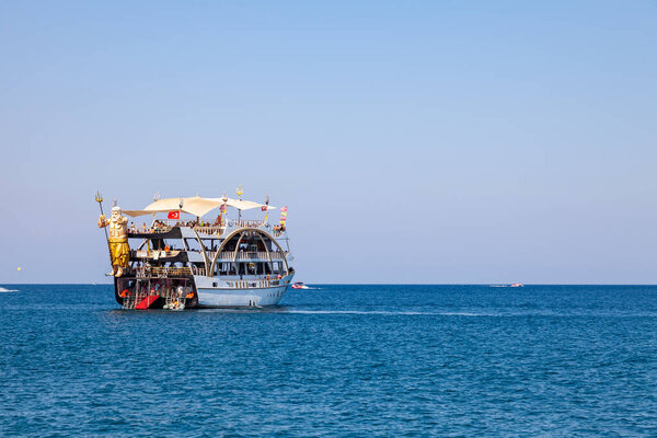 Kemer, Turkey - 08. 25. 2021: Big cruise ship Mega Star with tourists sailing in the sea in the hot summer day. Tourism and travel.