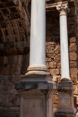 Antalya, hindi - 09. 01 numara. 2021: Antalya 'nın ünlü turist ve arkeolojik mekanının iki beyaz restore edilmiş sütunu İmparator Hadrian' ın eski kentteki kapısıdır. Seyahat yerleri, Türkiye 'de tatil
