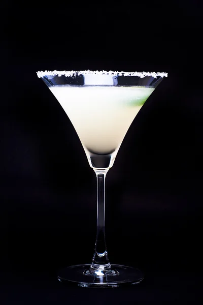 Margarita in glass with lime isolated on black background