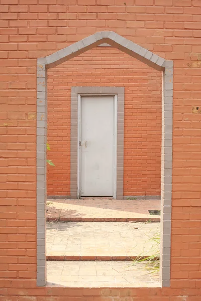 Brick wall & barred door — Stock Photo, Image