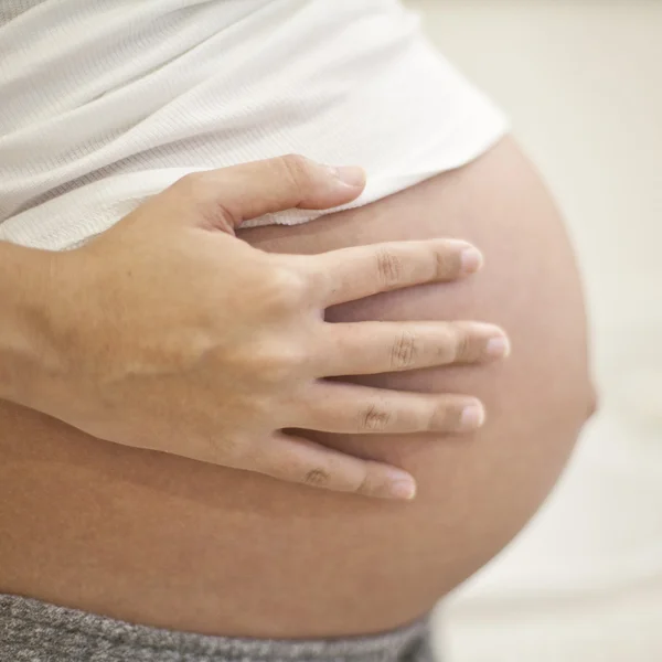 Image of pregnant woman touching her belly with hands — Stock Photo, Image