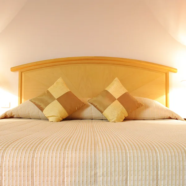 Bed in a hotel room at night — Stock Photo, Image