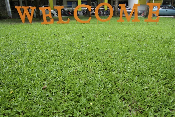 Texto de boas-vindas na grama verde — Fotografia de Stock