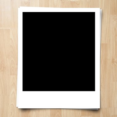 blank photo frame on brown wood plank background clipart
