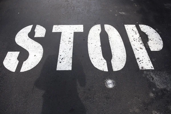 Stop text label on road — Stock Photo, Image