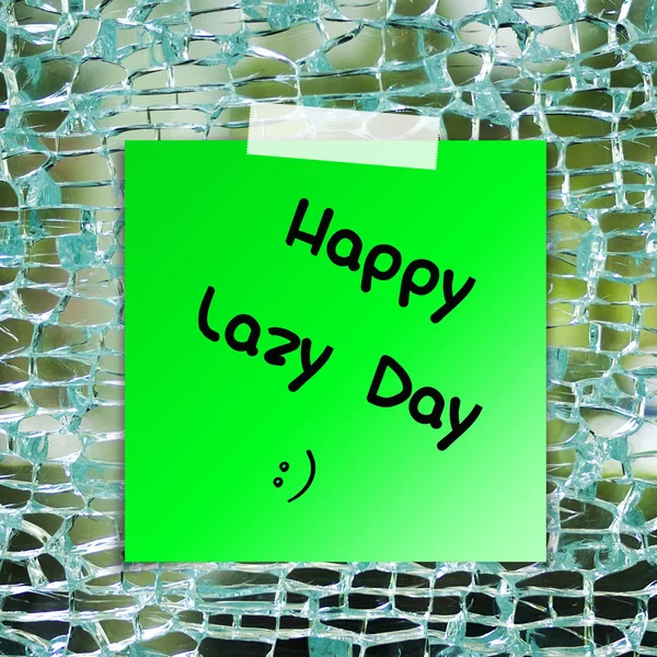 Happy líný den na lepící papír na pozadí rozbité sklo — Stock fotografie