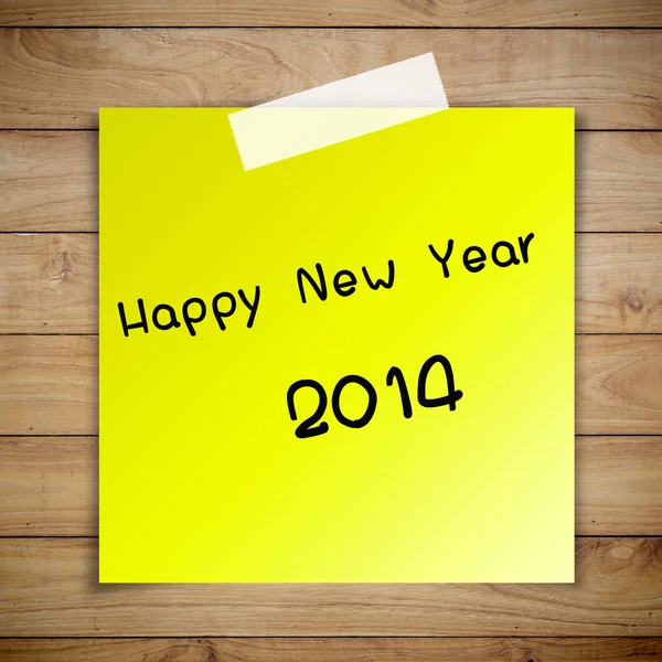 Gelukkig nieuw jaar 2014 op kleverige papier op bruin houten plank wall tex — Stockfoto