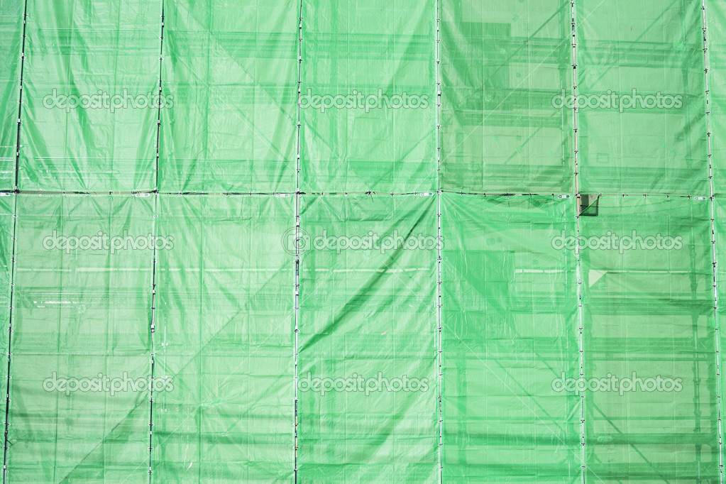 Green cloth cover on building construction site — Stock Photo © 2nix