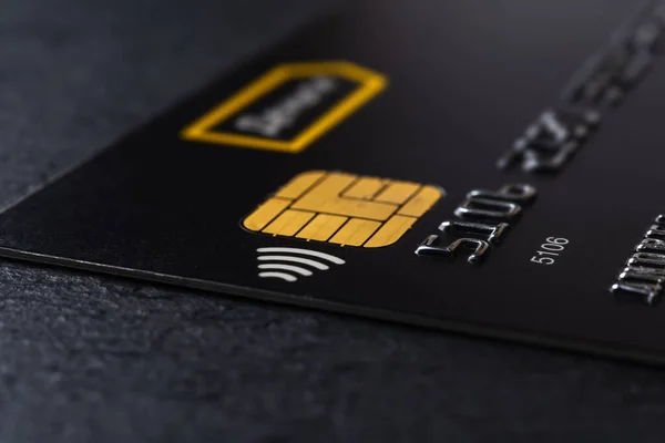 黒の背景にチップと非接触技術を持つ銀行のクレジットカード お金の送金や現金引き出しのためのブラックデビットカード カードで商品やサービスの支払い Dof — ストック写真