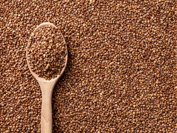 Wooden Spoon Full Organic Buckwheat Raw Wholegrain Groats Background Roasted — Stock Photo, Image