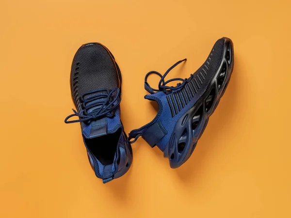 Laced Black Blue Mesh Fabric Sneakers Orange Background Pair Grooved — Stock Fotó