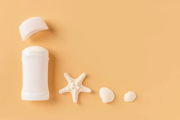 Open Solid Deodorant Antiperspirant Sea Star Shells Pastel Orange Background — стоковое фото