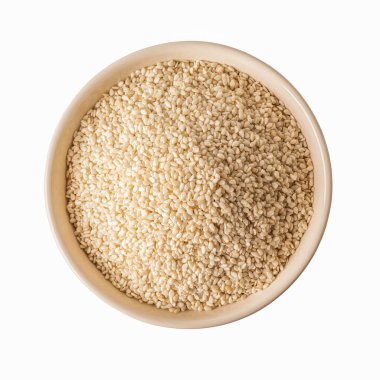 Top view of white sesame seeds in a beige bowl cutout. Raw organic  grains on a plate isolated on a white background. Sesamum indicum crop for boosting immunity diet and as calcium source. Closeup.