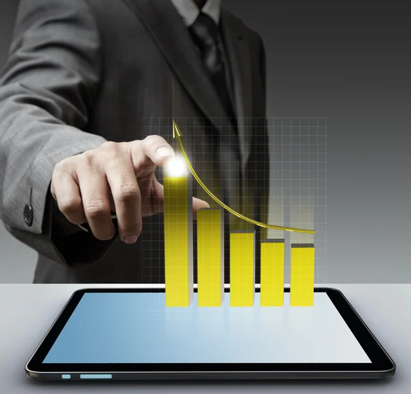 Hand point to virtual gold graph with tablet computer — Stock Photo, Image