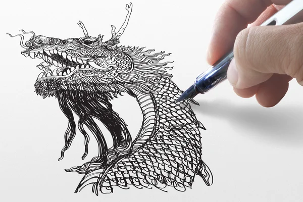 Main d'affaires dessine un dragon — Photo