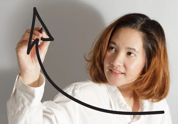 Businesswoman drawing a rising arrow — Stock Photo, Image