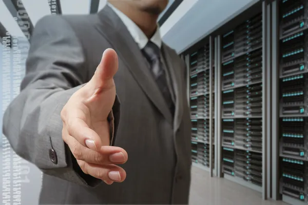 Businessmen offer hand shake in a technology data center — Stock Photo, Image