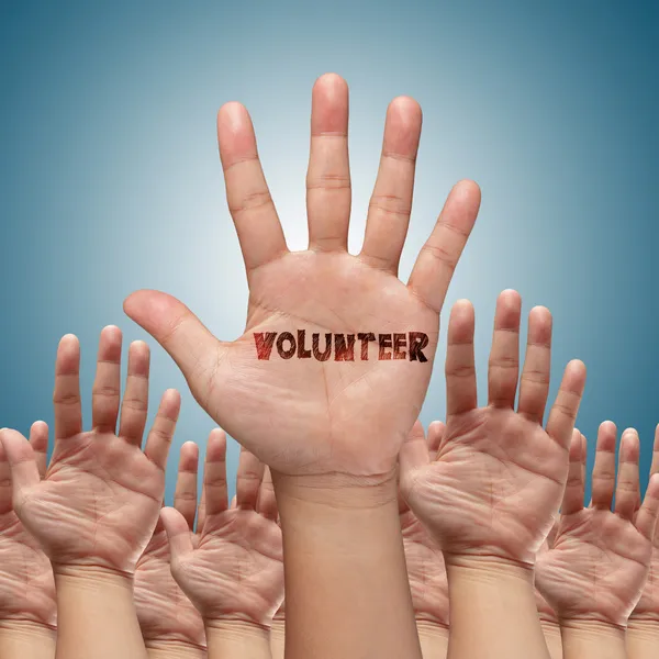 Volunteer group raising hands — Stock Photo, Image