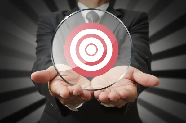 Businessman holds target business in round panel glass as concep — Stock Photo, Image