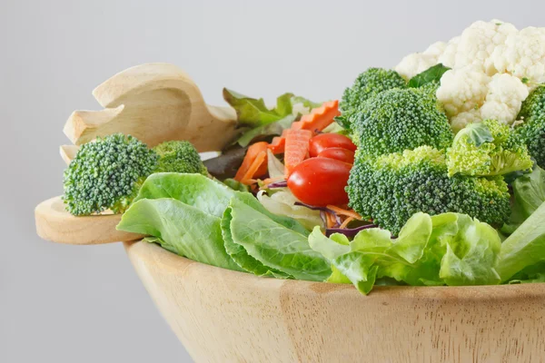 Wooden bowl of mixed salad — Stock Photo, Image