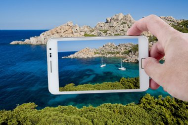 Taking a picture with Smartphone in Sardinia clipart
