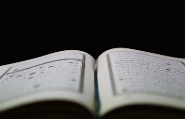 Siyah arkaplanı olan Kuran sayfalarını aç. surah yasin. Arapça harfleri de içerir. 