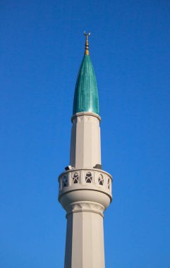 modern green minaret isolated on blue sky
