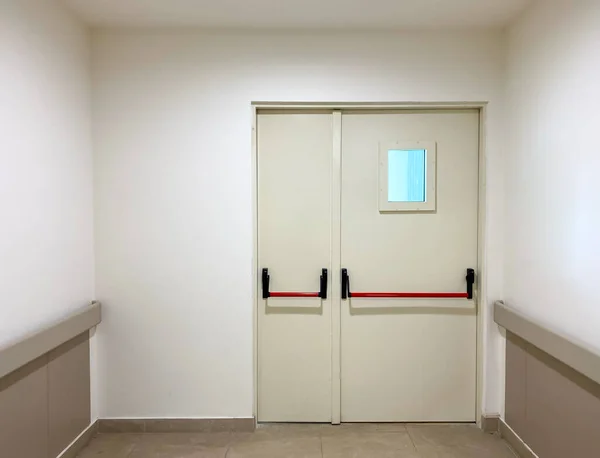 emergency exit door at the end of the corridor