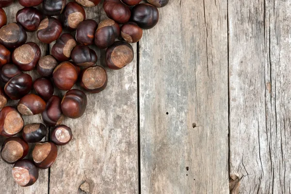 Closeup chestnuts on wooden desk — Stock Photo, Image