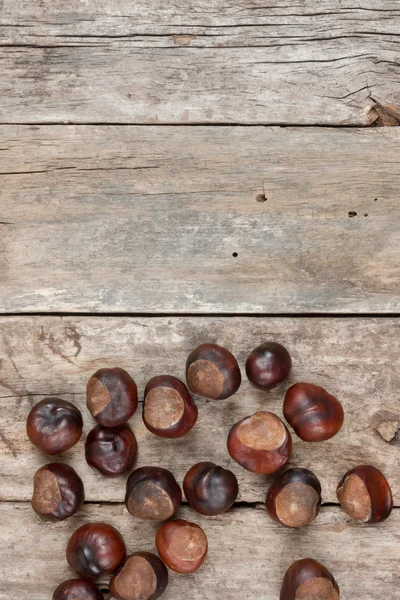 Closeup chestnuts on wooden desk — Stock Photo, Image