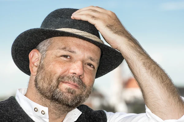 Man holding his Bavarian black hat — Stock Photo, Image