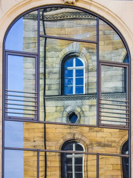 Mirroring of a old house in window — Stock Photo, Image