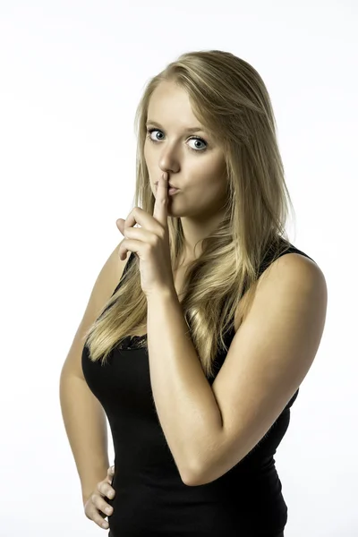 Young girl with finger on her mouth — Stock Photo, Image