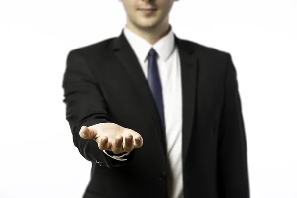 Businessman holds out his hand — Stock Photo, Image