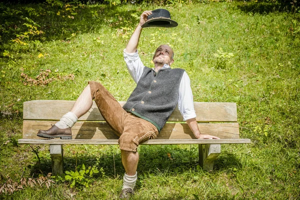 Bavarian man on bench — Stock Photo, Image