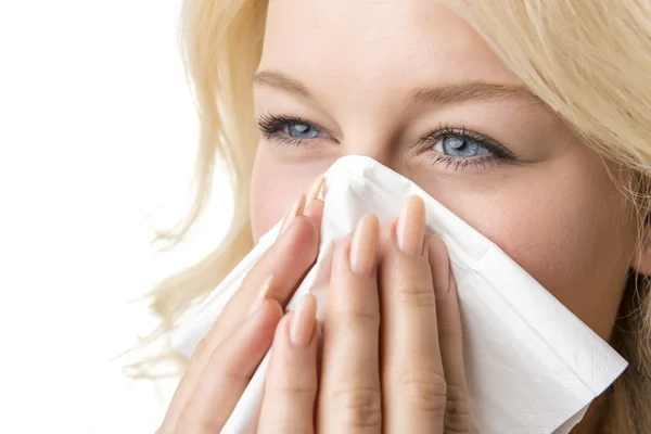 Ill woman with tissue is sneezing Stock Image