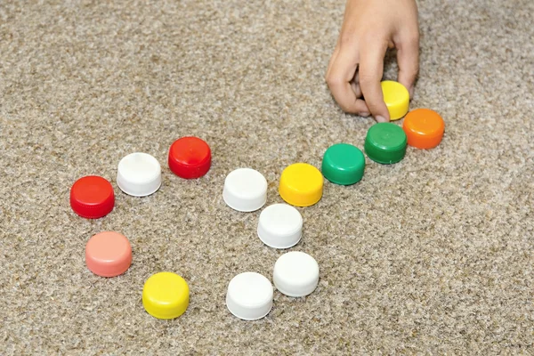 Children Playing with lids from soda — Stock Photo, Image
