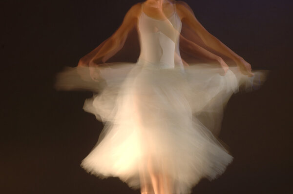Defocused picture of young ballerina dancing