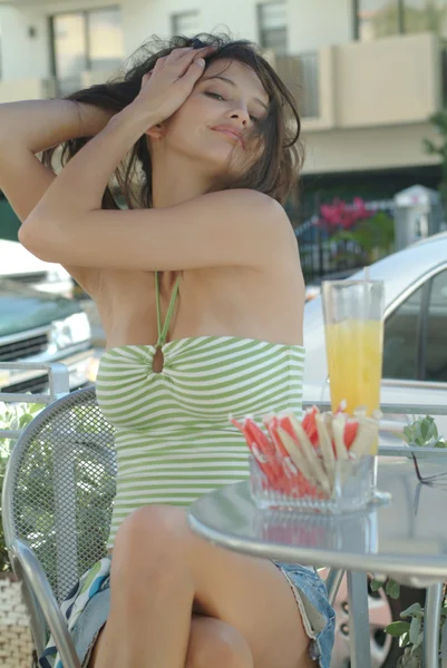 A young beautiful woman sitting in a cafe — Stock Photo, Image